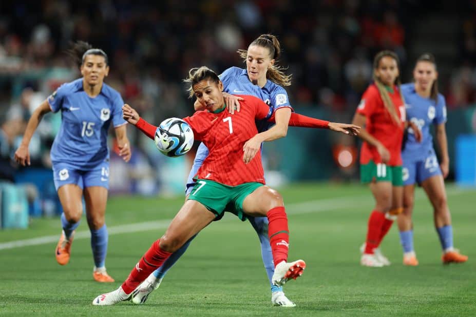 Morocco's Ghizlane Chebbak and France's Sandie Toletti compete for the ball. 